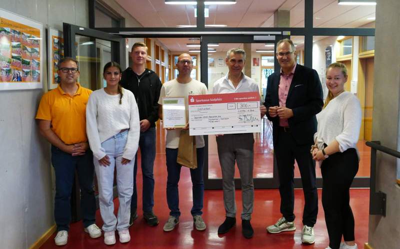 Landrat Dietmar Seefeldt (Zweiter von rechts) und SÜW-Klimaschutzmanagerin Agnes Bartmus (rechts) übergeben der Gebrüder-Ullrich-Realschule plus Maikammer-Hambach den Scheck fürs Schulradeln. Foto. Realschule plus Maikammer-Hambach. Frei. 