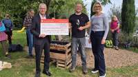 Monika Wind vom Standesamt der Stadt Landau und Thomas Pfaffmann vom Wein.Gut.Pan (Mitte) und übergeben einen Scheck über 1.000 Euro an Pfarrer Martin Anefeld. Foto. Stadt. LD. Frei. 